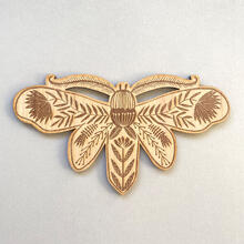 Etched wooden moth decoration